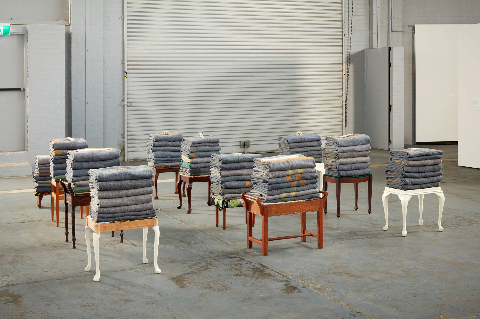 Olga Cironis, Naked Whisper, 2020, military blankets, 12 stools, bones, dimensions variable
