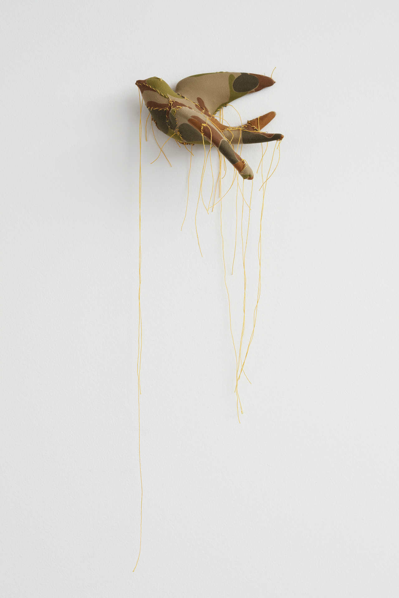 Olga Cironis, Dove, 2018, repurposed porcelain ornament, military fabric and cotton thread, 14 x 18 x 10cm