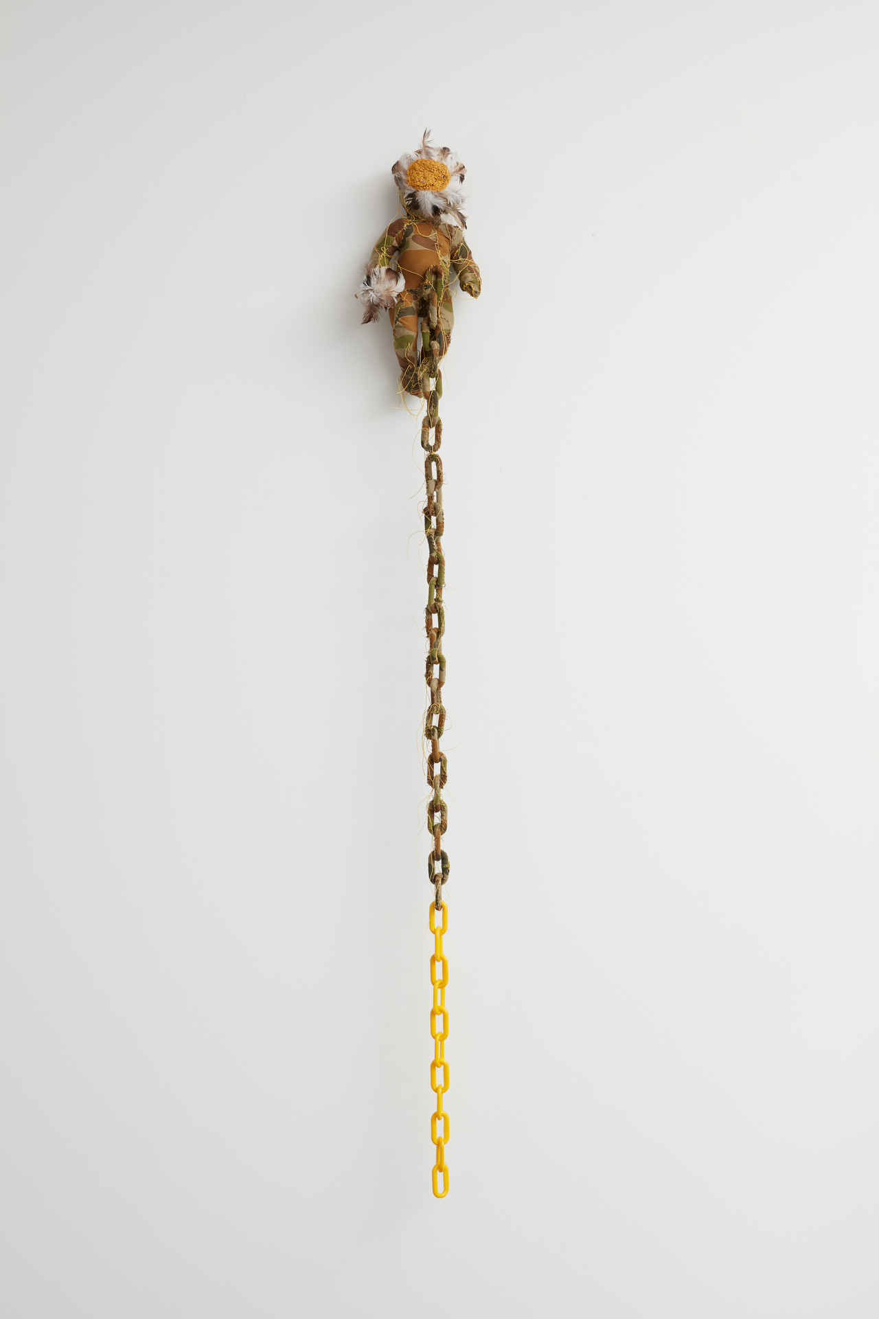 Olga Cironis, Yellow, 2019, repurposed toys, military fabric, feathers, plastic toy chain and thread, 148 x 17 x 12cm