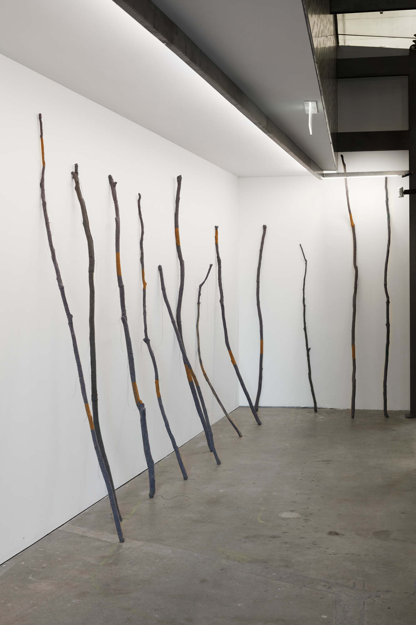 Olga Cironis, Drawn by a Promise, 2021, wooden sticks, woollen blanket and cotton thread, installation dimensions variable