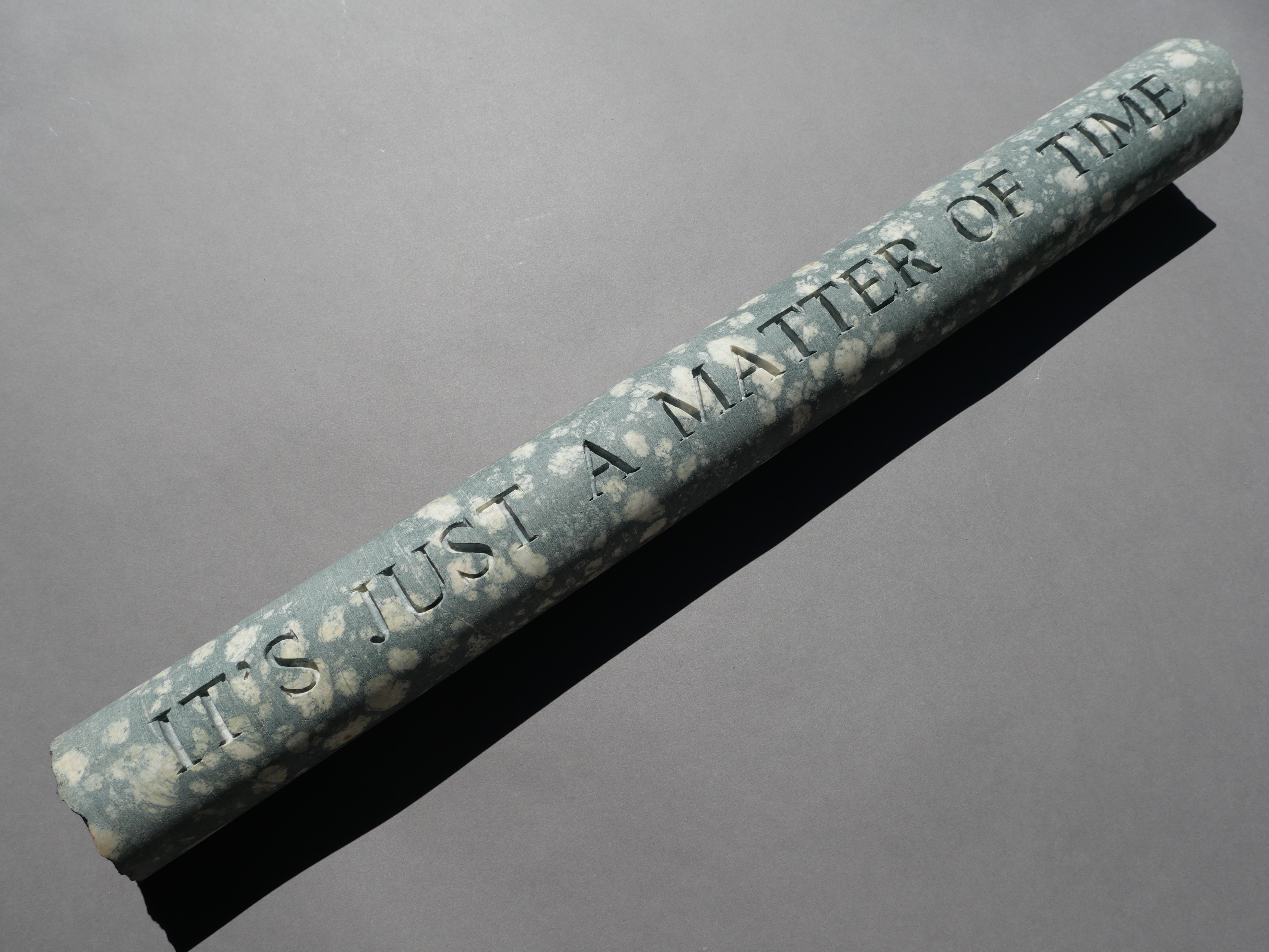 Lee Harrop, It’s Just a Matter of Time, 2021, hand-engraved geological core sample (from the Goldfields, Yilgarn Craton, WA), 58 x 6cm, 5kg