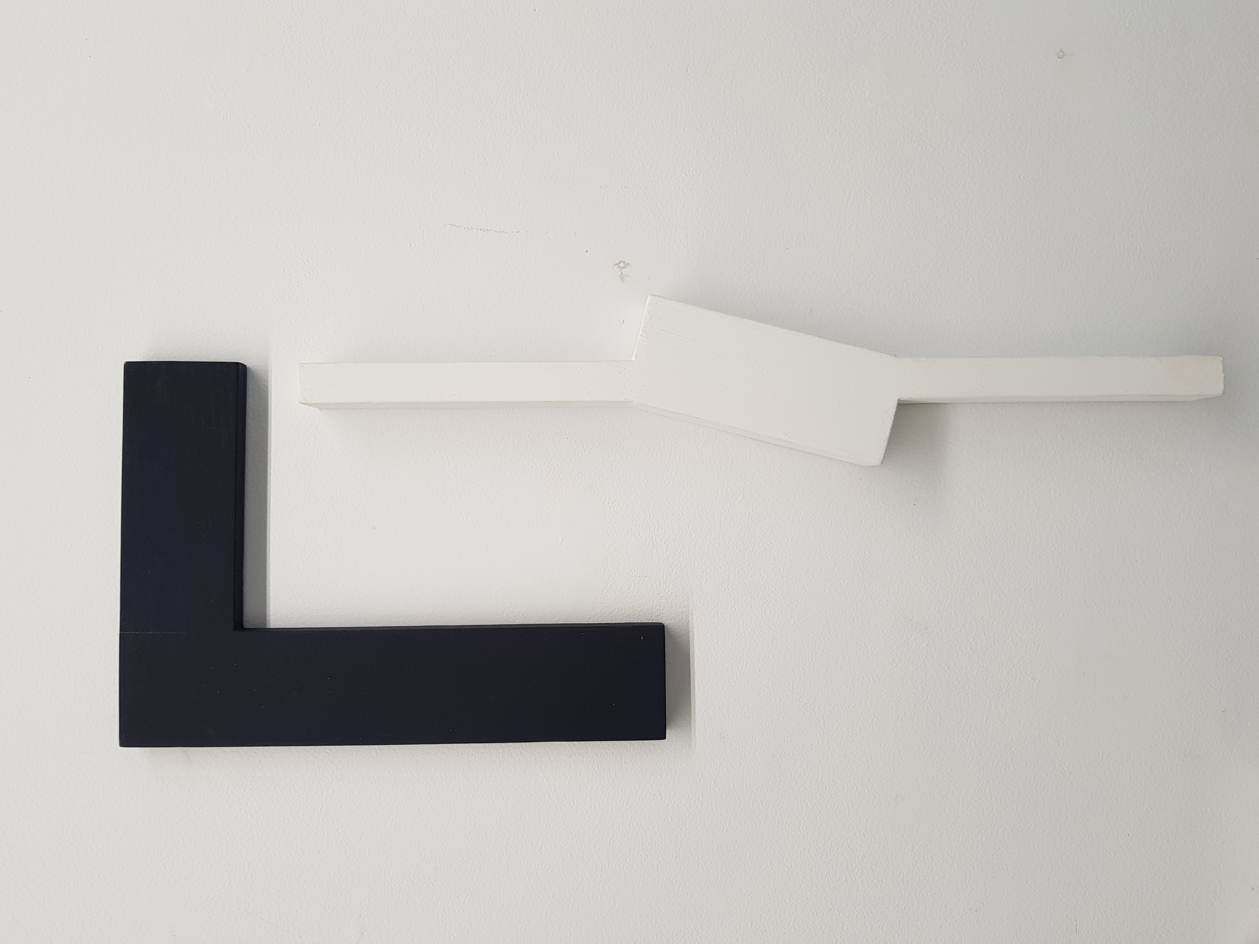 Theo Koning, It's Only Black and White 41, 2018, acrylic paint on wood, 30 x 21 x 1.5cm and It's Only Black and White 33, 2018, gesso on wood, 50 x 9 x 3cm