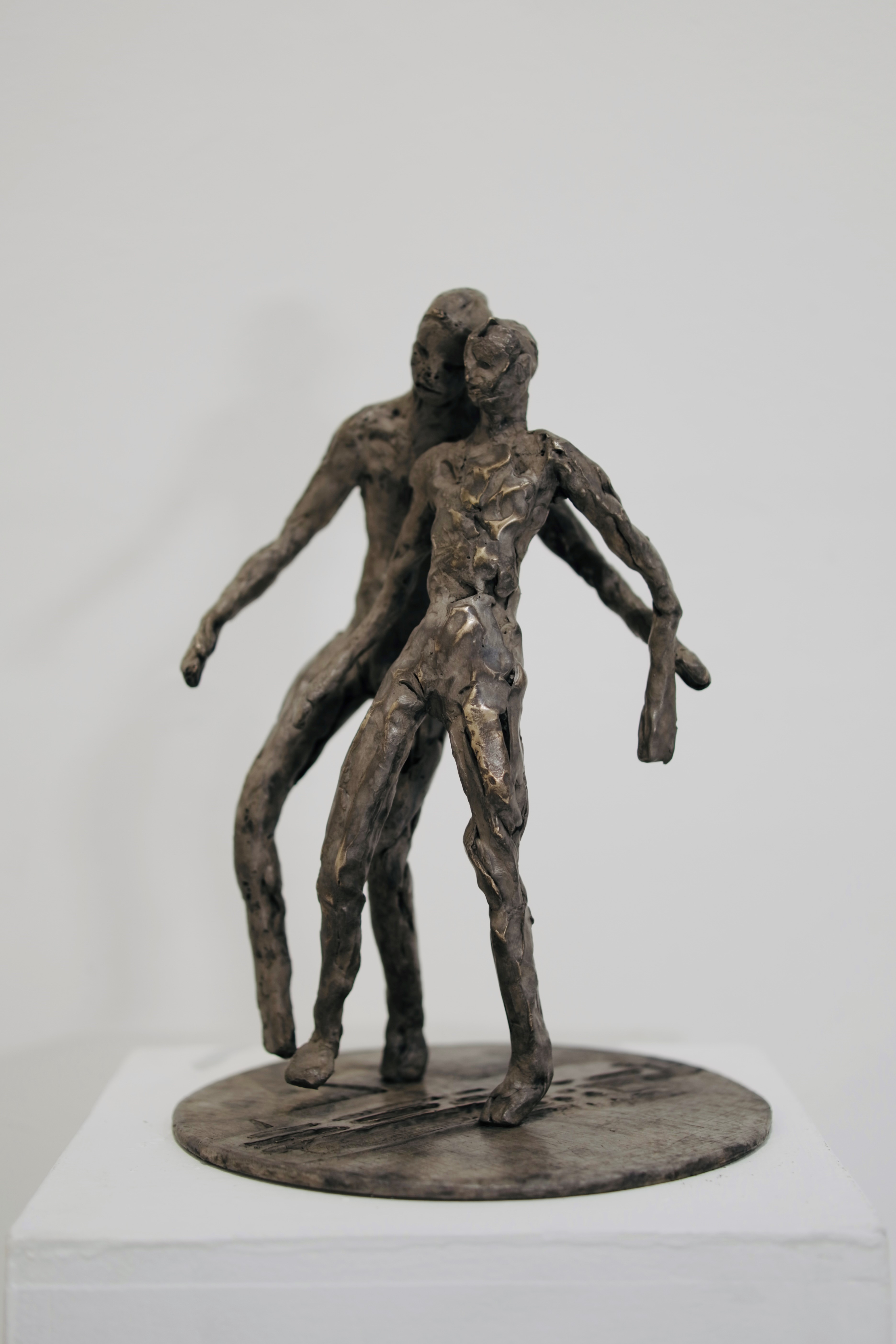 Jon Tarry, Double Hold - an embrace of the unknown, 2023, bronze lost wax cast and silver nitrate patina, 60 x 8 x 8cm