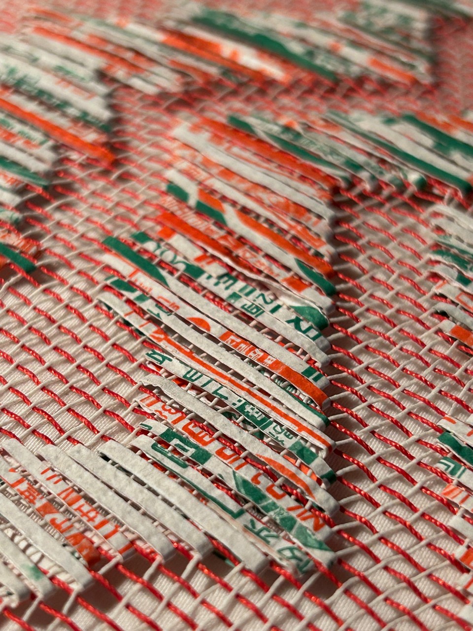 Jacky Cheng, Thrums, 2023, nylon, paper, thread, Chinese calendar, Tyvek and joss papers, 630 x 37cm