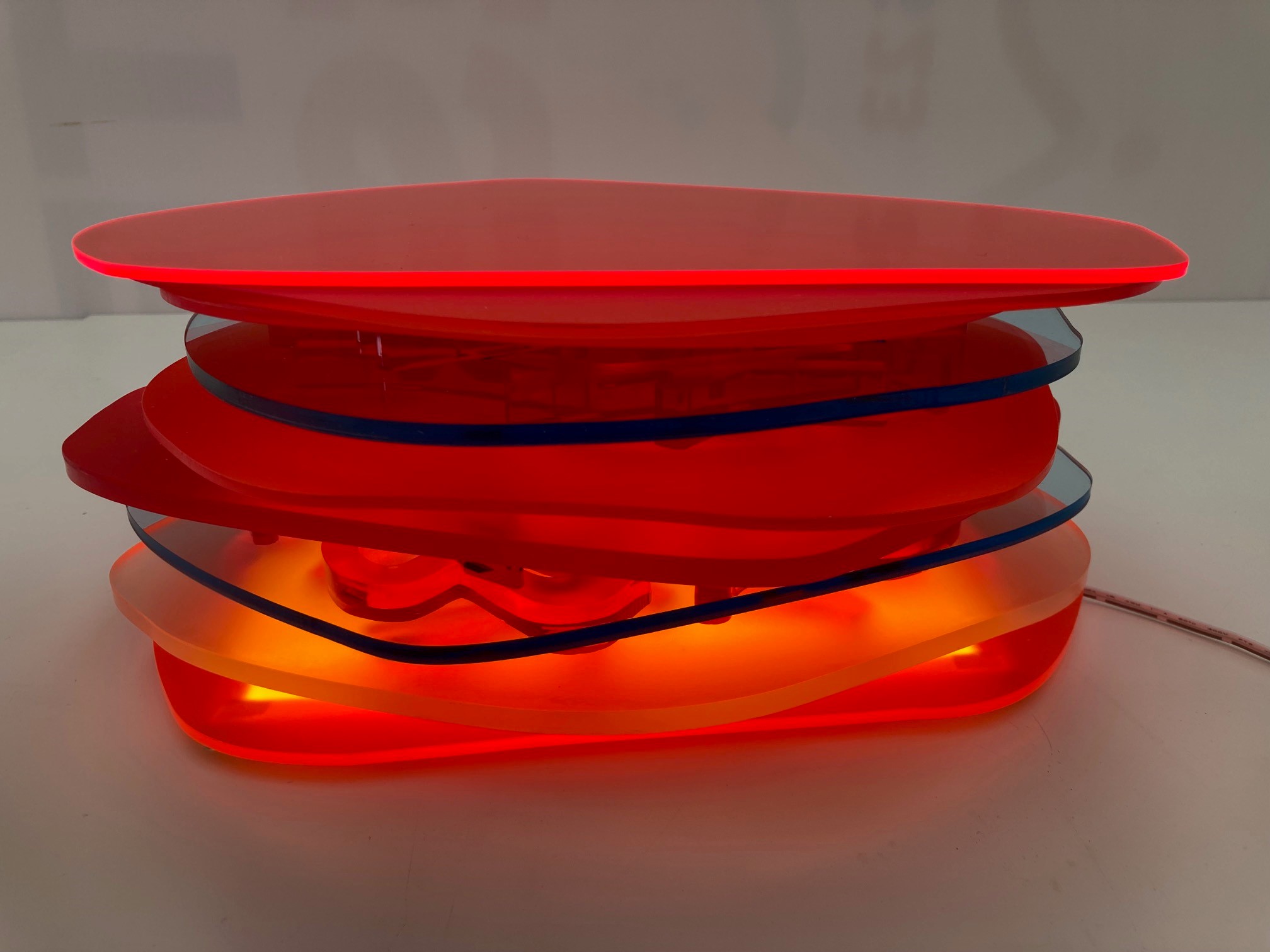 Pamela Gaunt, Fandango III (Illuminated Horizontal Stack), 2023, laser-cut and assembled Plexiglass and Perspex off-cuts from Not Quite Wabbly and a public art project, and vinyl tape, 11 x 25 x 25cm