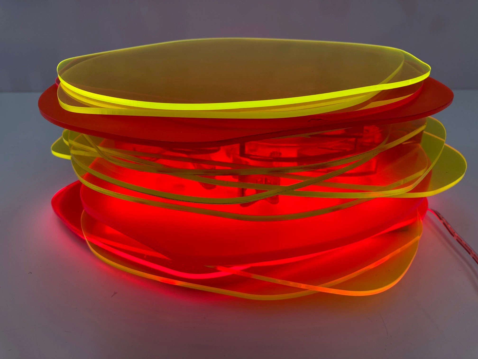 Pamela Gaunt, Fandango IV (Illuminated Horizontal Stack), 2023, laser-cut and assembled Plexiglass and Perspex off-cuts from Not Quite Wabbly and a public art project, and vinyl tape, 11 x 25 x 25cm