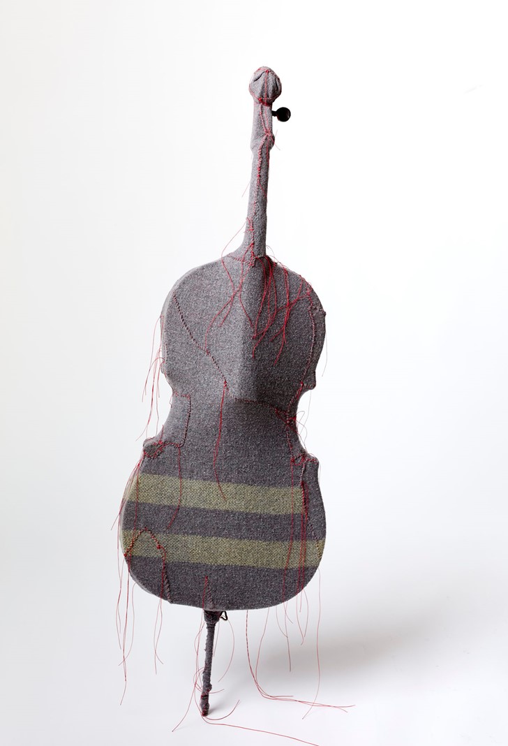 Olga Cironis, Apo, 2024, repurposed cello, woollen blanket and cotton thread, 127 x 40 x 12cm