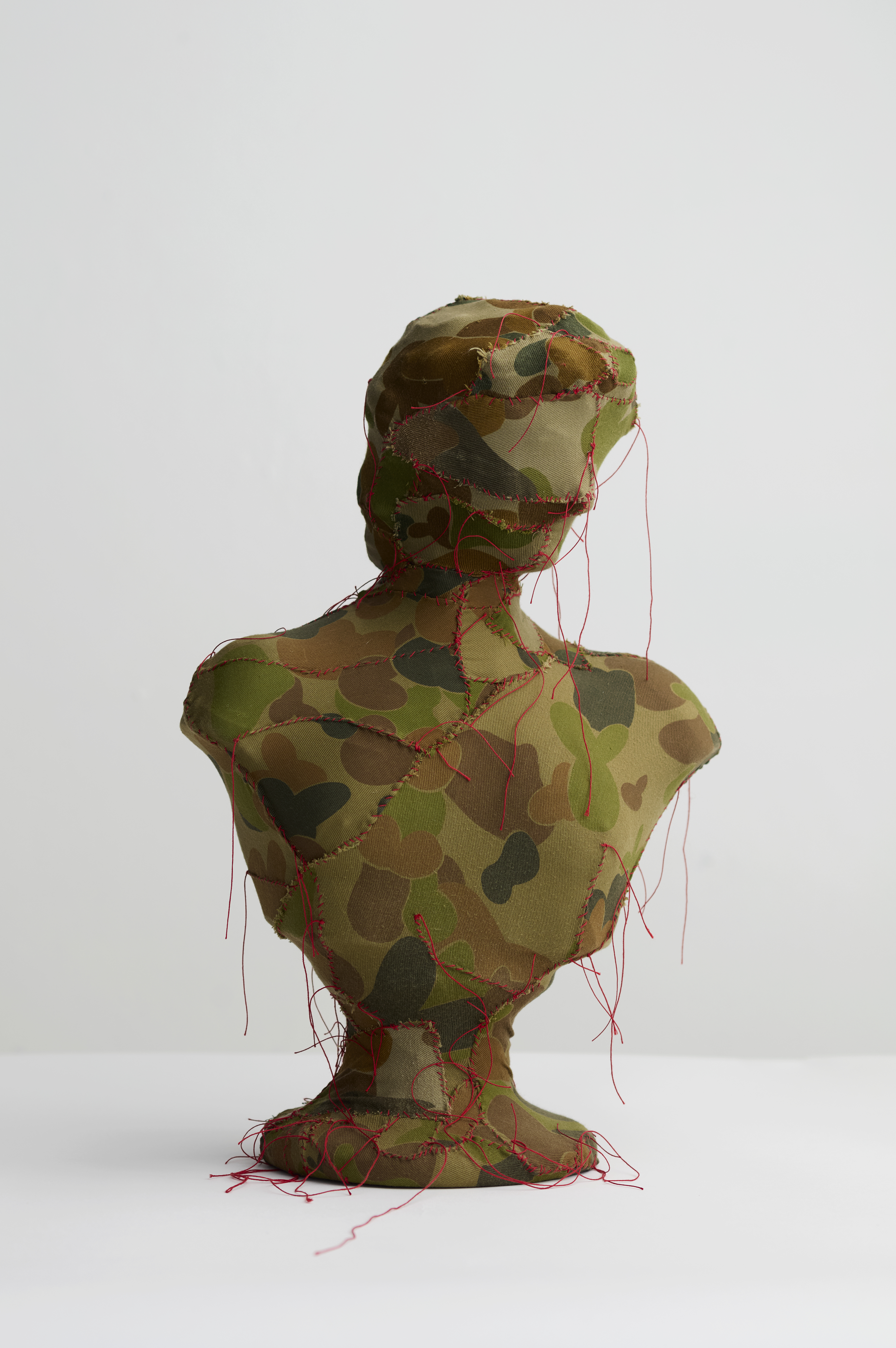 Olga Cironis, Angry Gods 3, 2023, repurposed ceramic ornament, camouflage fabric and cotton thread, 46 x 32 x 17cm