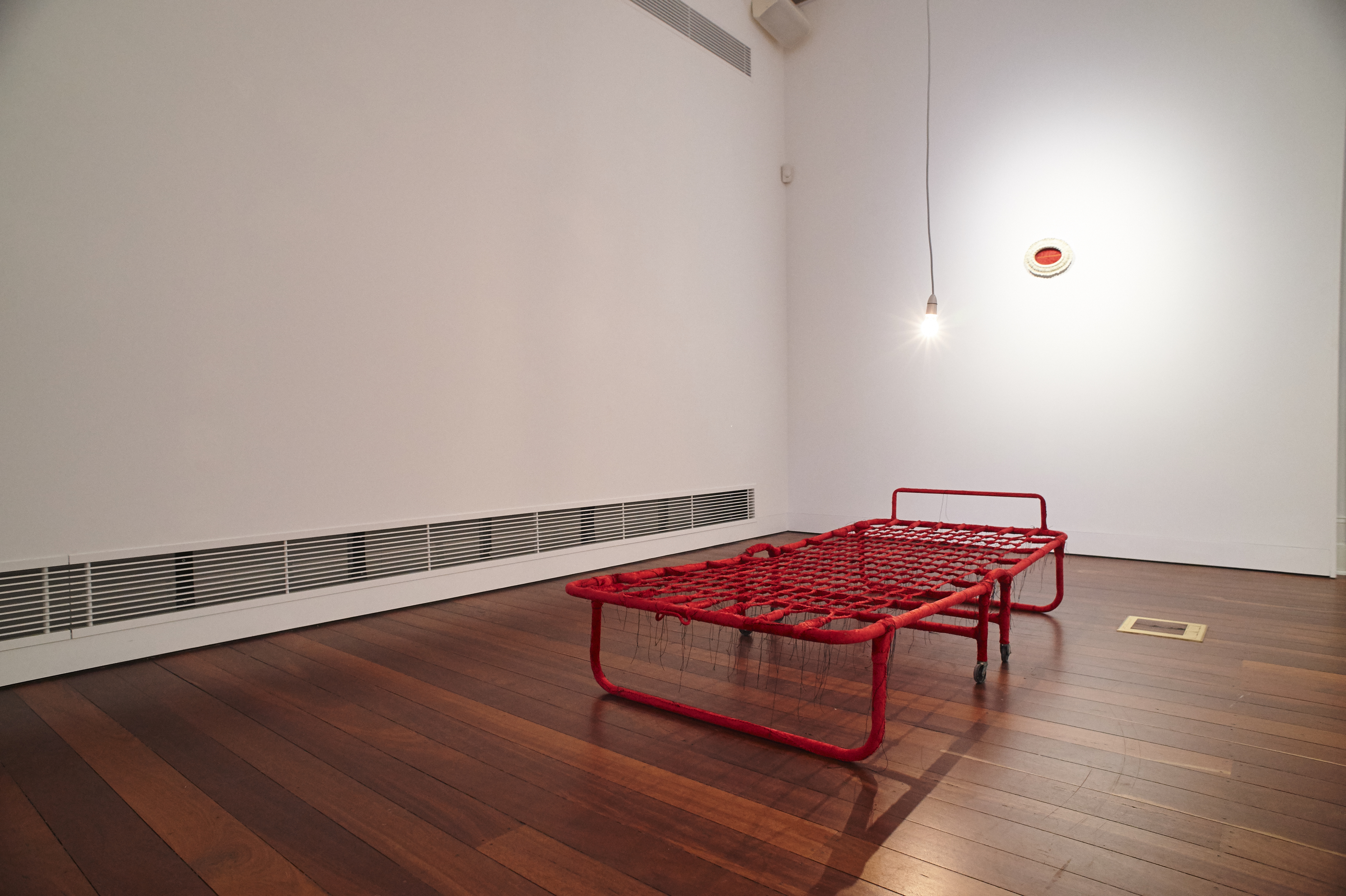 Olga Cironis, Untitled, 2022, repurposed fold-out bed, velvet and cotton thread with light globe, 30 x 80 x 180cm