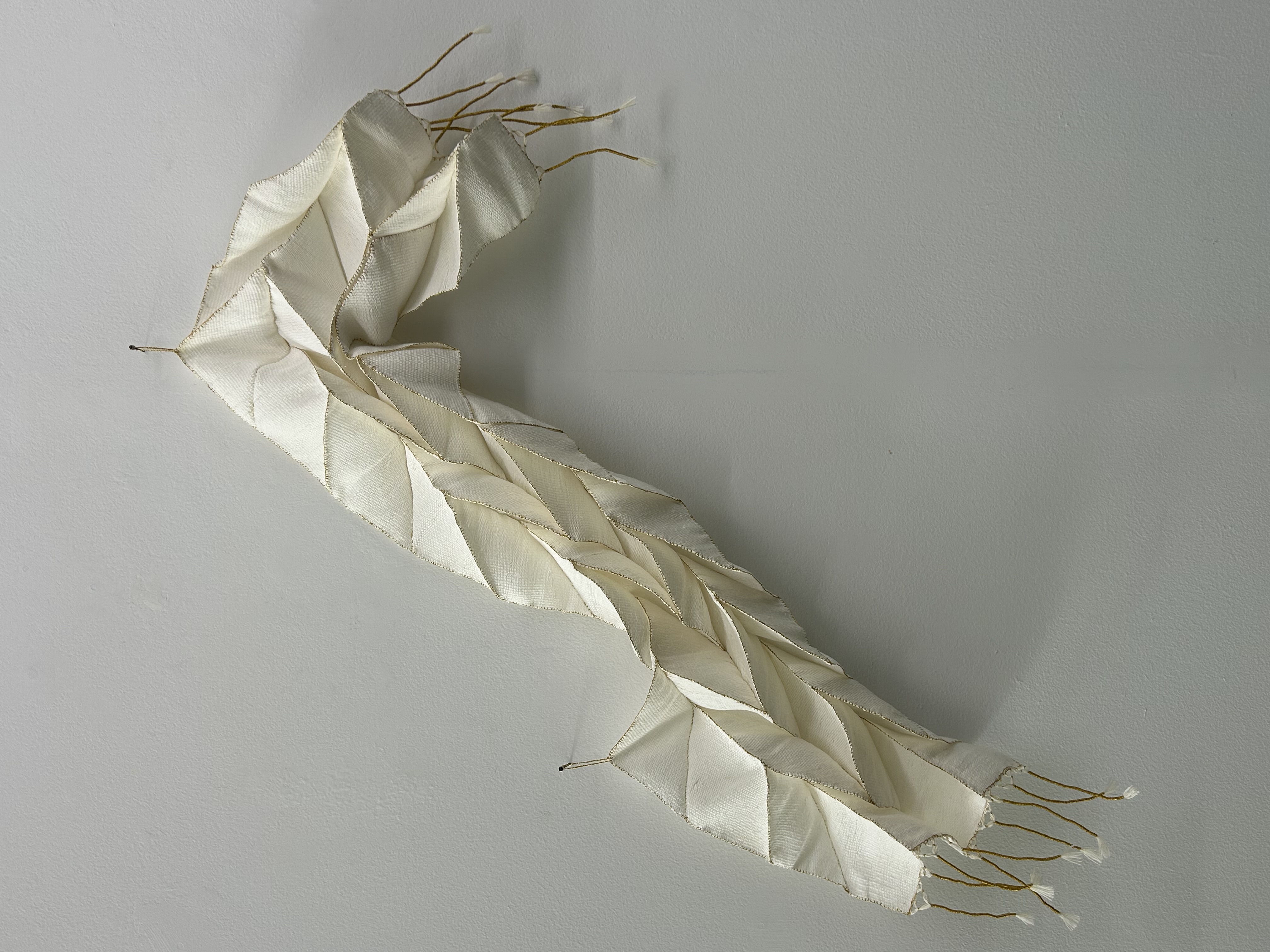 Jacky Cheng, Echo in the Fold II, 2025, hand-rolled paper thread, gold leaf thread and wool, 120 x 40 x 4cm