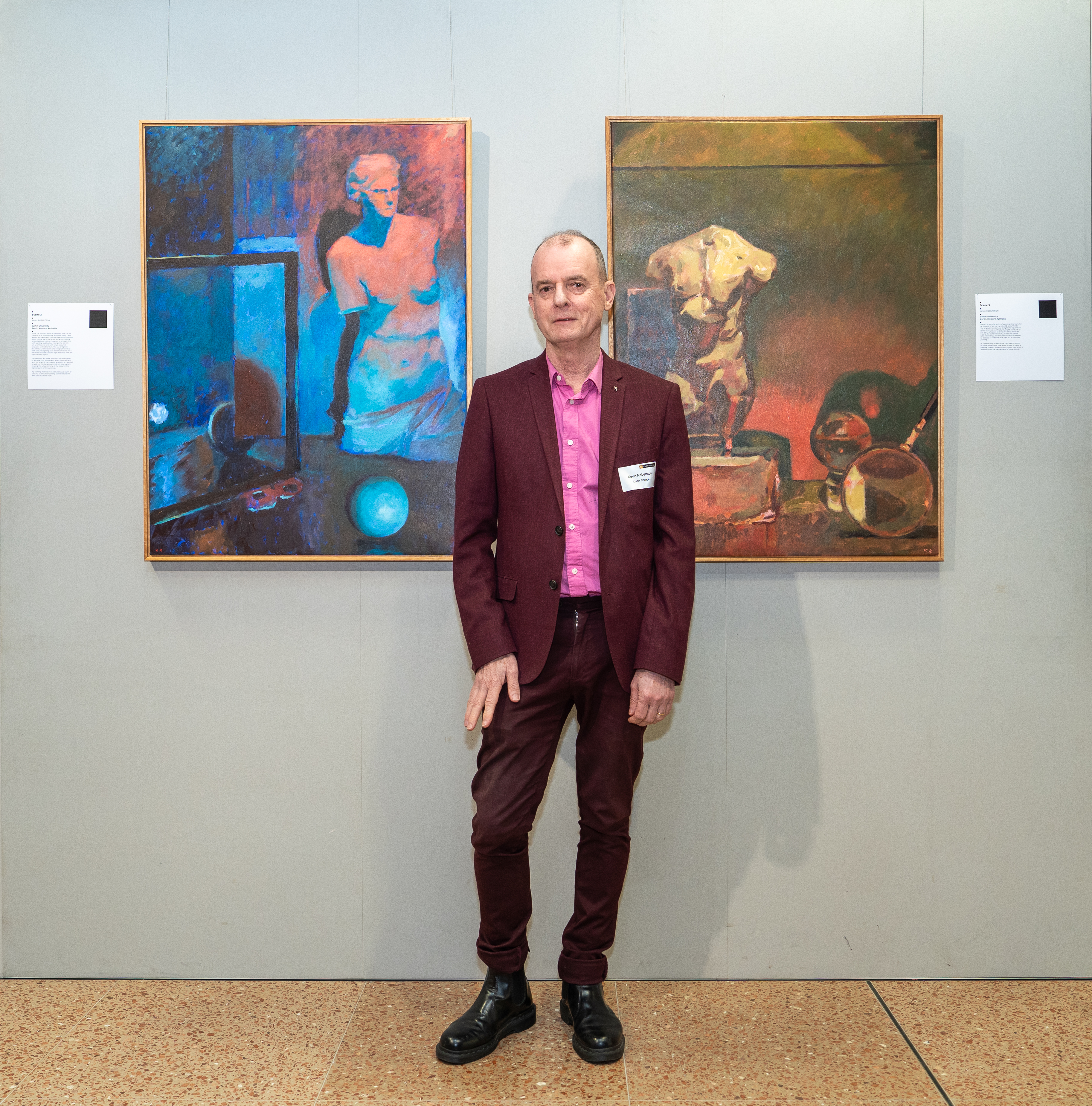 Kevin Robertson pictured with his artworks at ROYGBIV: A Celebration of Colour