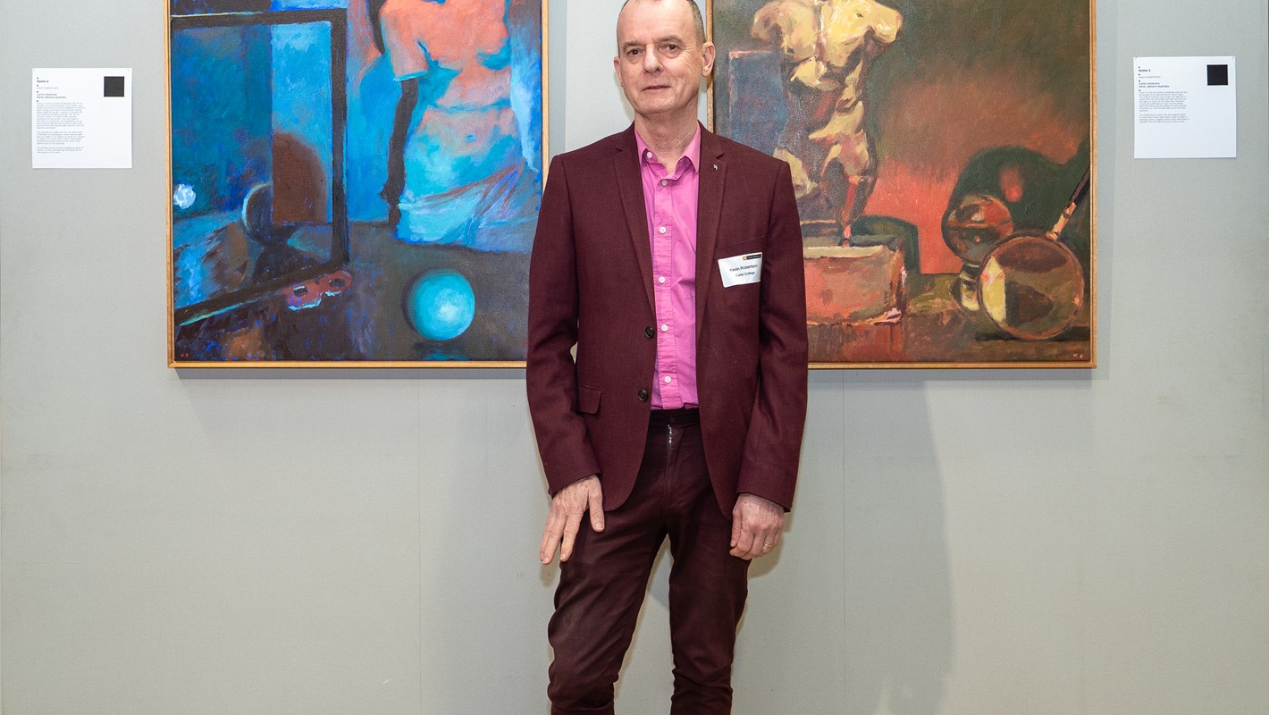 Kevin Robertson pictured with his artworks at ROYGBIV: A Celebration of Colour