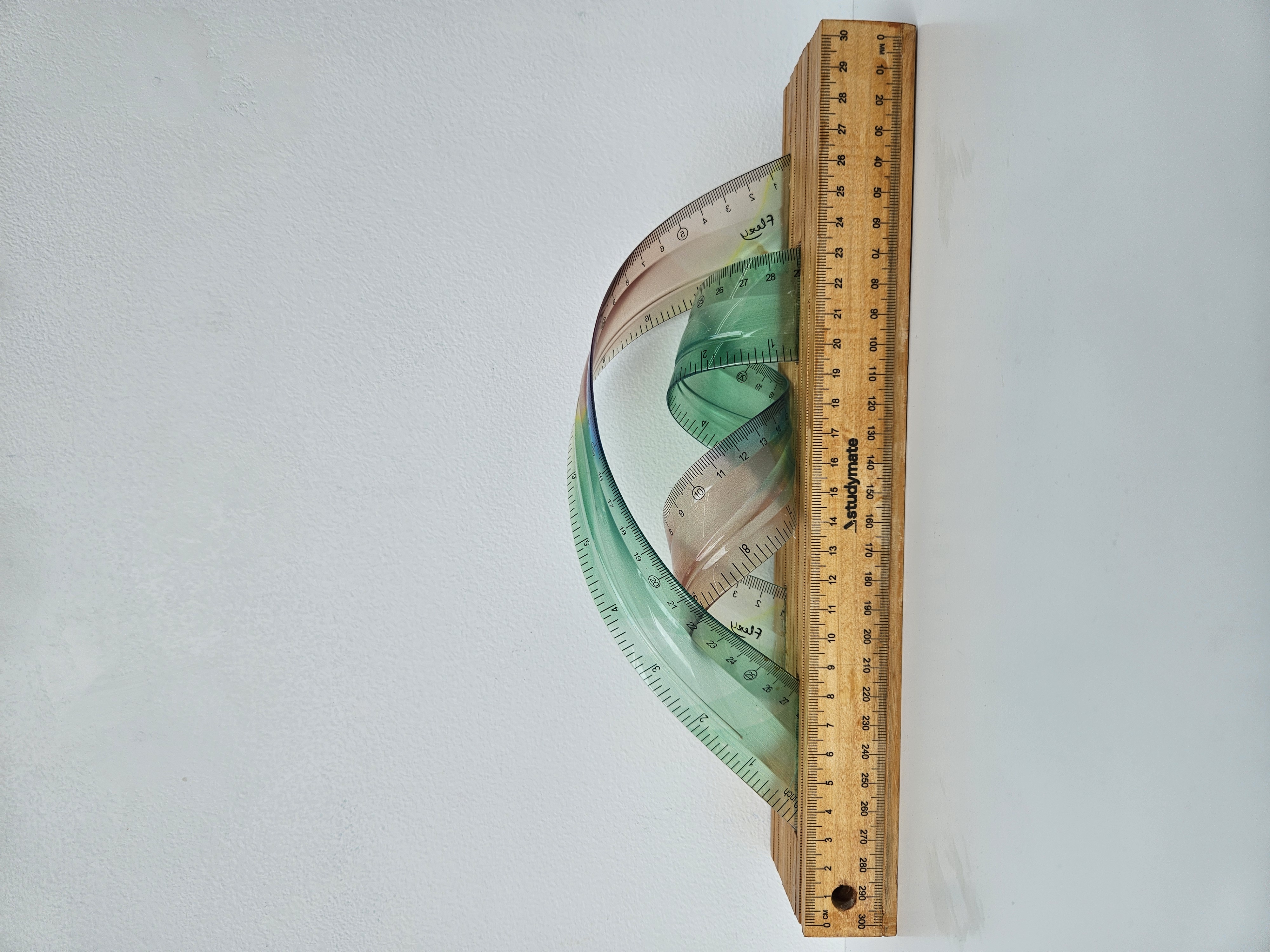 Minaxi May, Flexi Spectrum, 2026, plastic rulers and wood, 11.5 x 31 x 6cm